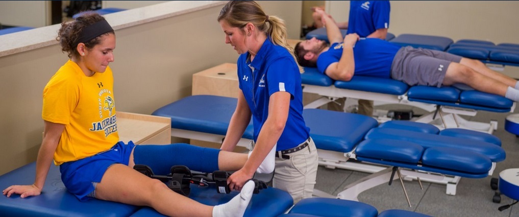 View of athletic trainer working with athlete.